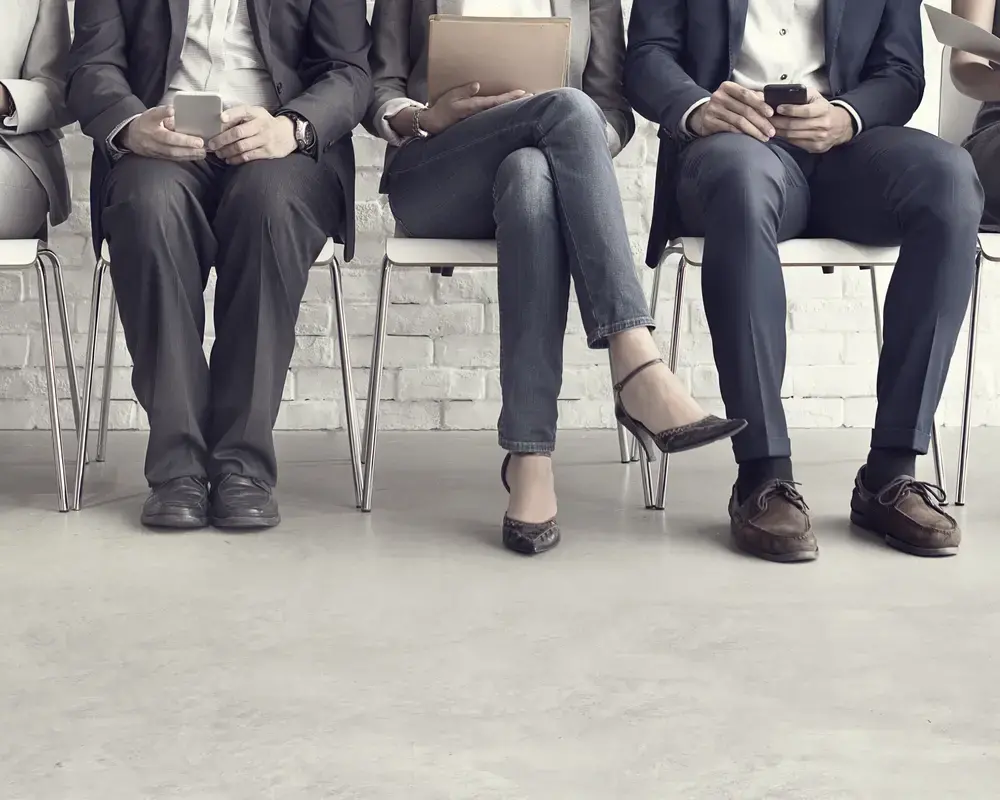 Group of people sitting in a row for interview