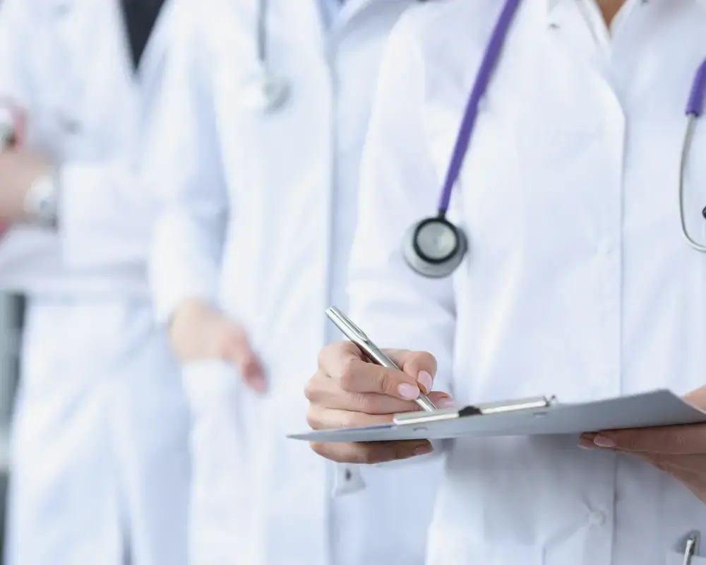 doctor using pen and clipboard