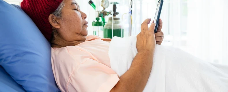 Oncology Clinical Outcome Assessment Solutions | Asian Elderly Patient on iPad
